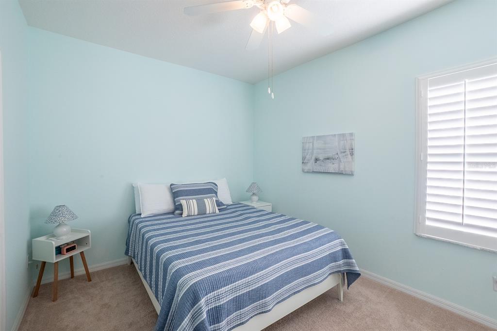 47 Summerwind Circle Palm Coast, FL 32137 - Photo 22 of 32 a bedroom with a bed and a chair