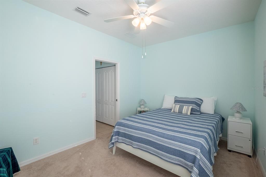47 Summerwind Circle Palm Coast, FL 32137 - Photo 23 of 32 a bedroom with a bed and a chandelier