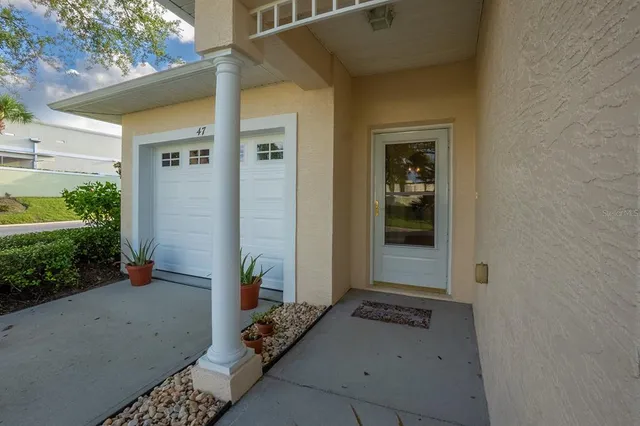 a view of a house with a big yard and large trees