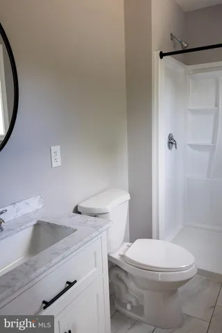 a white toilet sitting next to a bathroom sink