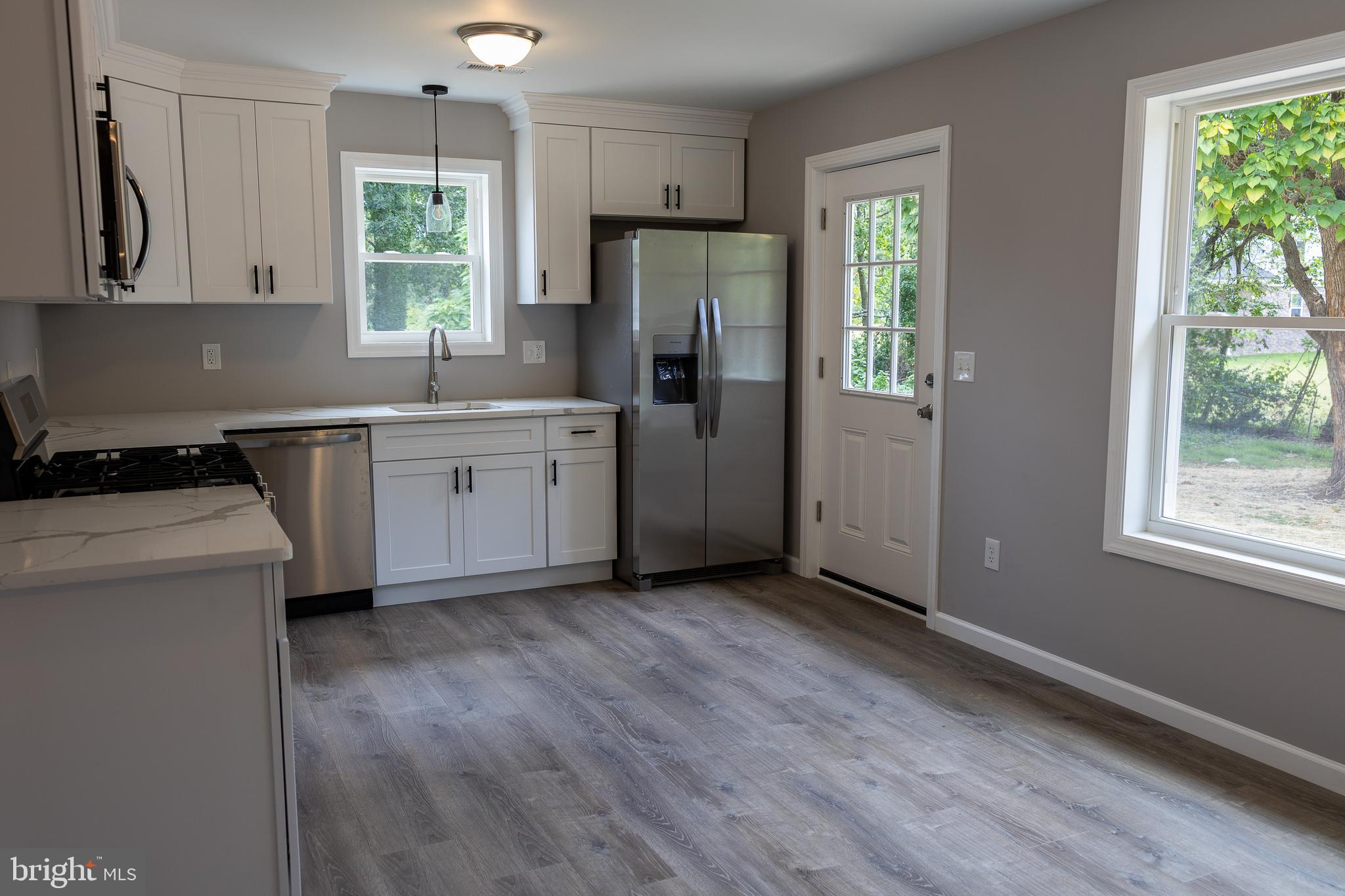 348 Colfax Street Bridgeton, NJ 08302 - Photo 4 of 26 a kitchen with a refrigerator a stove a sink and a window