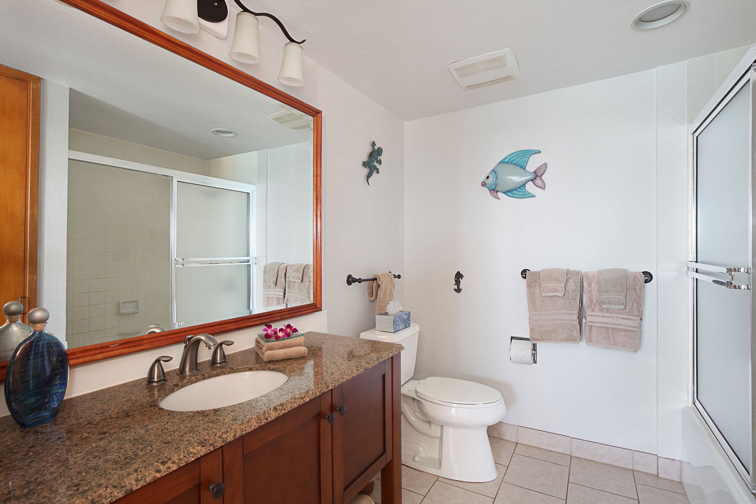 1661 Pee Road, Unit IIA312 Koloa, HI 96756 - Photo 11 of 30 a bathroom with a granite countertop sink a toilet and a mirror