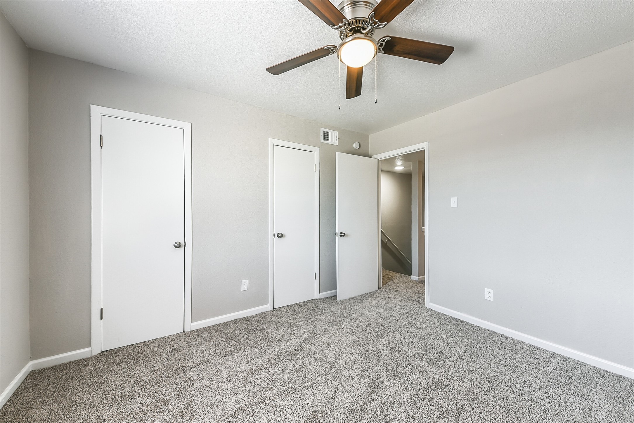 8271 Stone Street, Unit 7107 Houston, TX 77061 - Photo 16 of 28 an empty room with closet and a chandelier fan
