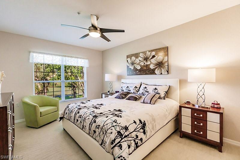 8135 Celeste Drive, Unit 4218 Naples, FL 34113 - Photo 21 of 37 Bedroom with light carpet and ceiling fan