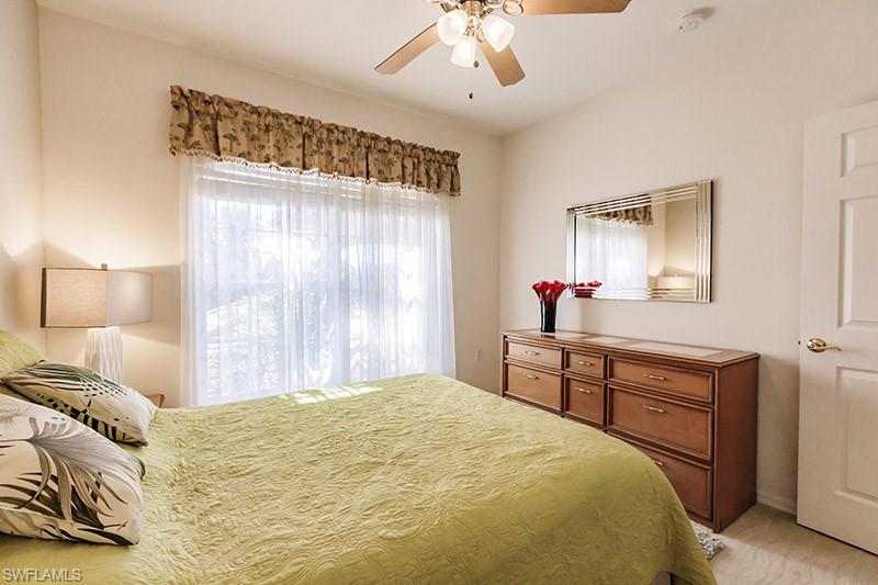 8135 Celeste Drive, Unit 4218 Naples, FL 34113 - Photo 27 of 37 Carpeted bedroom with ceiling fan
