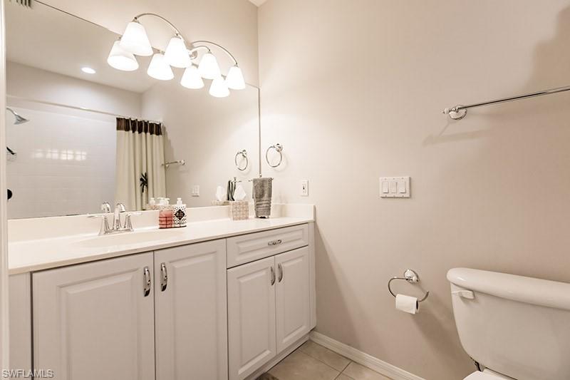 8135 Celeste Drive, Unit 4218 Naples, FL 34113 - Photo 29 of 37 Bathroom with vanity, toilet, and tile patterned flooring