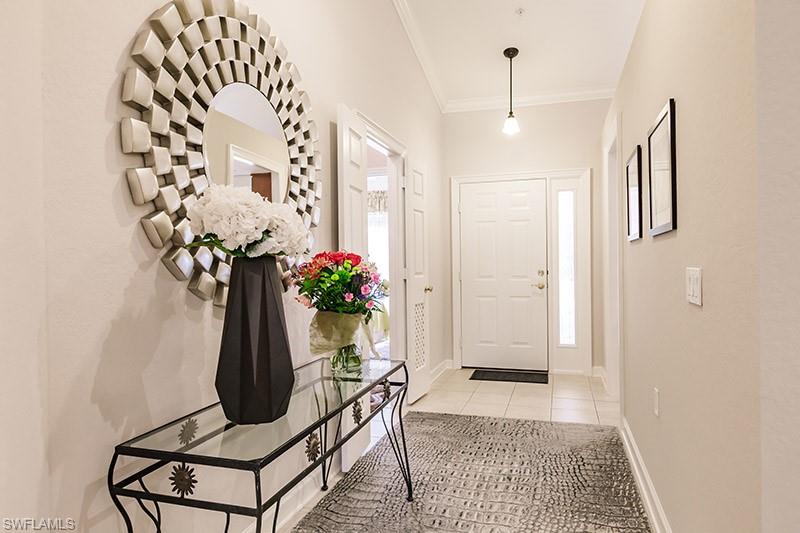 8135 Celeste Drive, Unit 4218 Naples, FL 34113 - Photo 3 of 37 Tiled foyer featuring ornamental molding