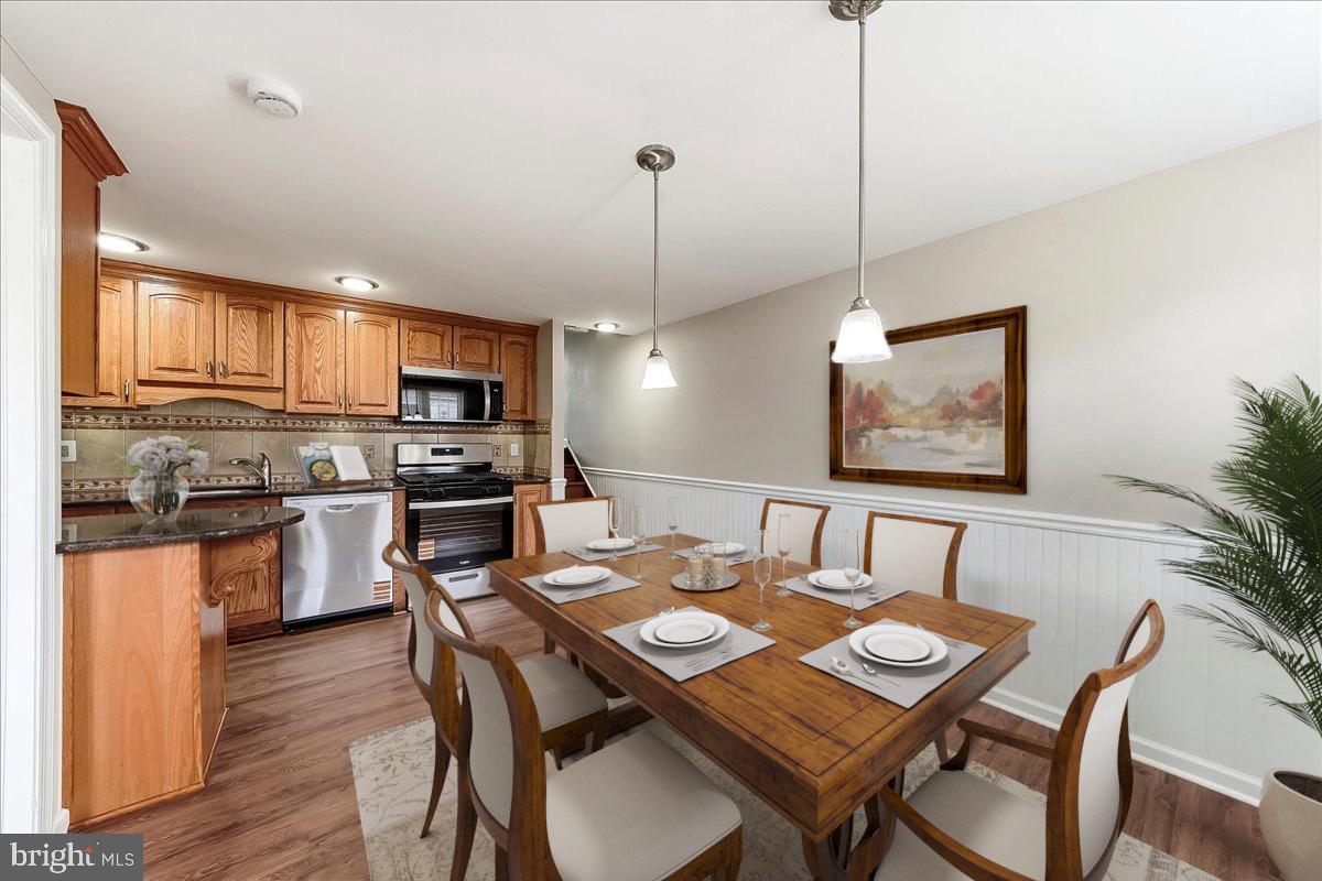 159 Chadwick Avenue Linwood, PA 19061 - Photo 1 of 35 a kitchen with a wooden table chairs cabinets and stainless steel appliances