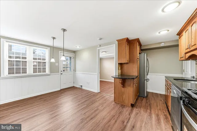 a kitchen with stainless steel appliances granite countertop a refrigerator and a stove top oven