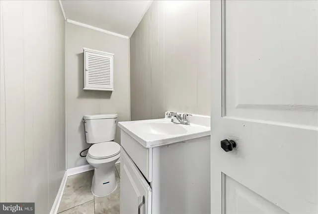 a bathroom with a sink toilet and a window