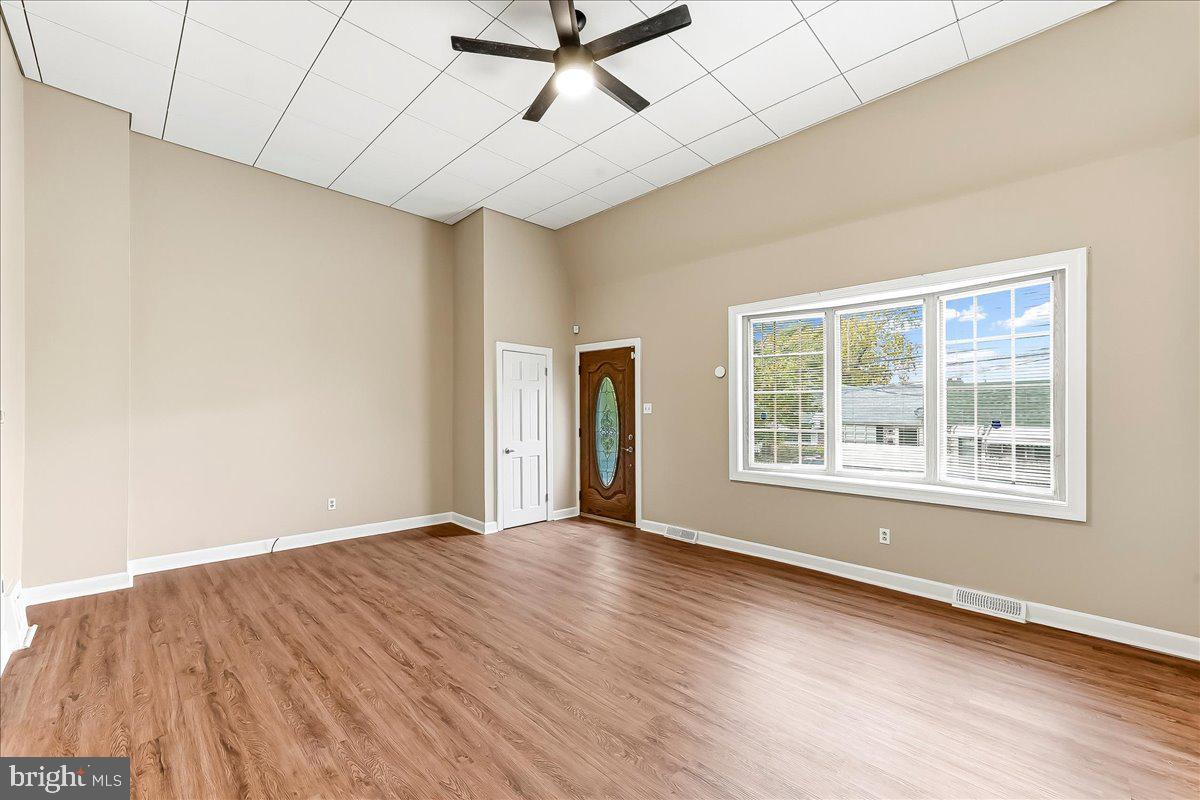 159 Chadwick Avenue Linwood, PA 19061 - Photo 3 of 35 a view of an empty room with wooden floor and a window