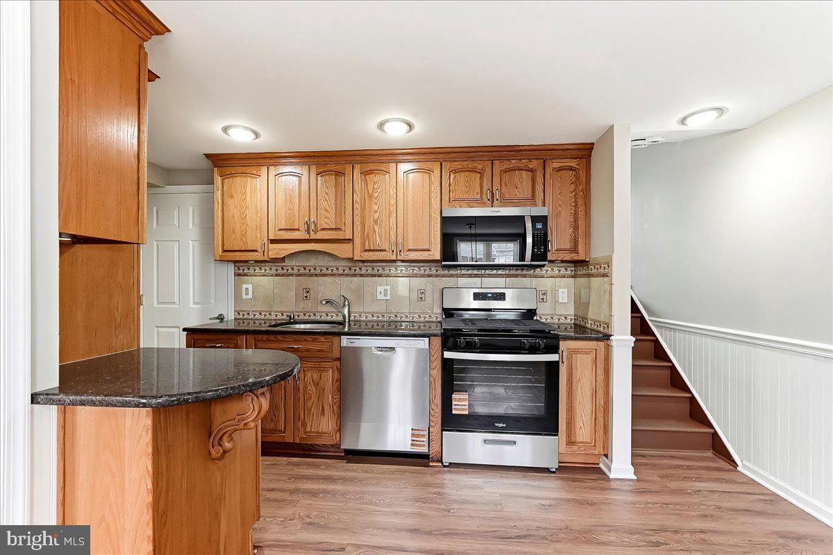 159 Chadwick Avenue Linwood, PA 19061 - Photo 9 of 35 a kitchen with stainless steel appliances granite countertop a stove a sink and a microwave
