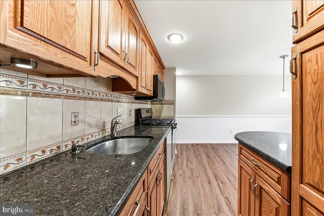 a kitchen with a sink a counter top space and cabinets