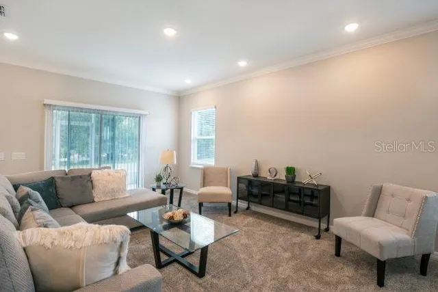 a living room with furniture and a large window