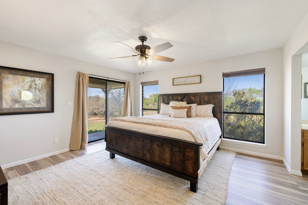 3410 West Ranch Road 152 Llano, TX 78643 - Photo 14 of 36 Bedroom with access to outside, light wood-style flooring, and ceiling fan
