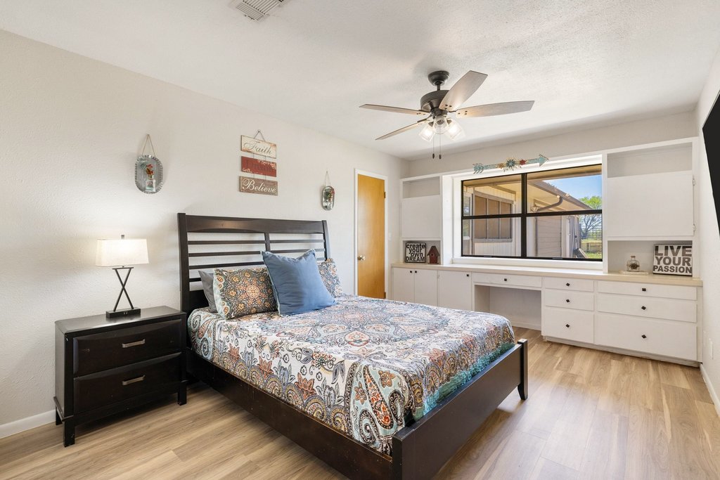 3410 West Ranch Road 152 Llano, TX 78643 - Photo 20 of 36 Bedroom featuring light wood-style flooring and ceiling fan
