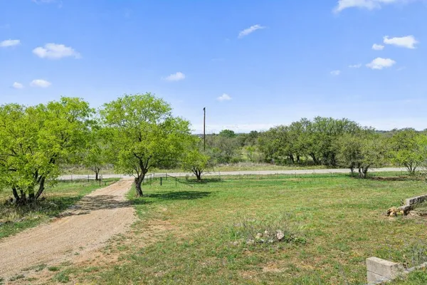 a view of field with trees in the background