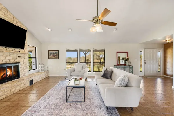 a living room with furniture and a large window