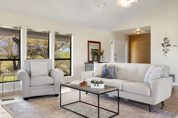 a living room with furniture fireplace and a flat screen tv