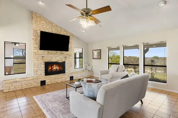 a living room with fireplace and a flat screen tv