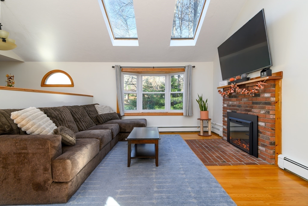 12 Hickory Road Millville, MA 01529 - Photo 12 of 41 a living room with furniture a flat screen tv and a fireplace