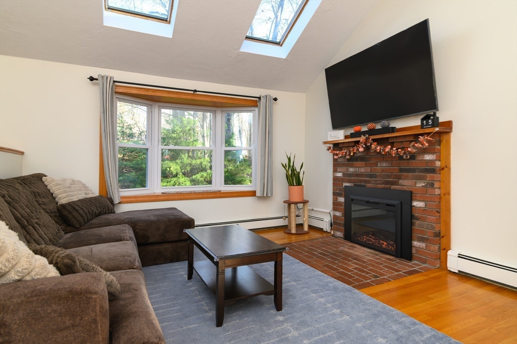 12 Hickory Road Millville, MA 01529 - Photo 13 of 41 a living room with furniture a flat screen tv and a fireplace