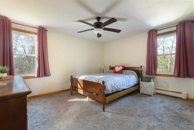 a bedroom with a bed and window