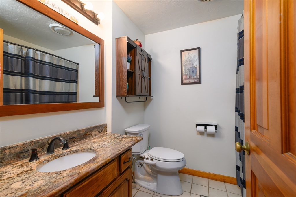 12 Hickory Road Millville, MA 01529 - Photo 25 of 41 a bathroom with a granite countertop toilet sink and mirror