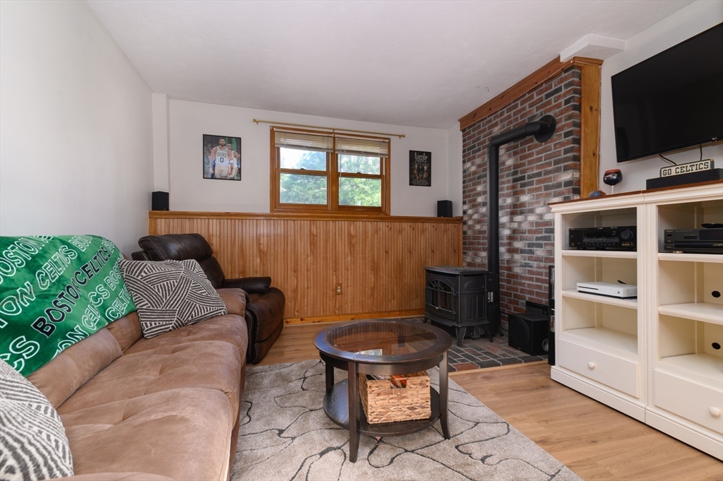 12 Hickory Road Millville, MA 01529 - Photo 28 of 41 a living room with furniture a flat screen tv and a fireplace