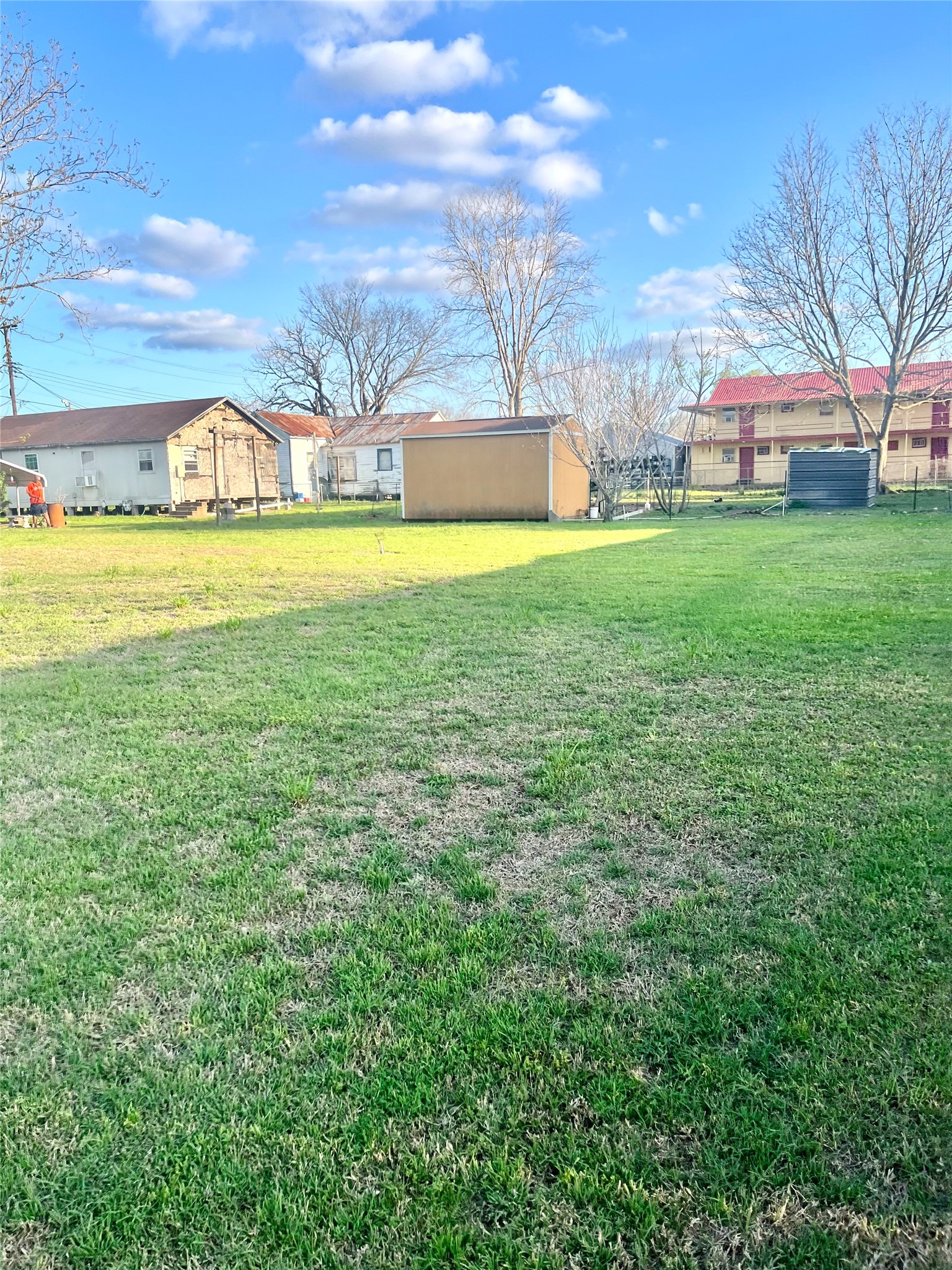 1006 Back Street Columbus, TX 78934 - Photo 4 of 5 a view of a house with a big yard and large trees