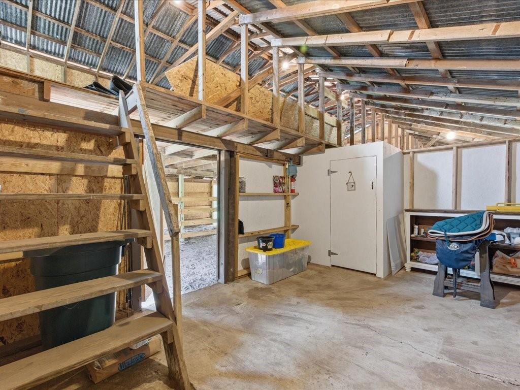 1085 Duke Road Kennard, TX 75847 - Photo 30 of 40 Interior barn space featuring exposed wood framing and a corrugated metal ceiling