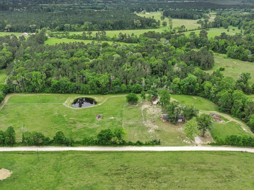 1085 Duke Road Kennard, TX 75847 - Photo 34 of 40 Expansive rural property featuring a large pond, extensive green acreage, and mature trees