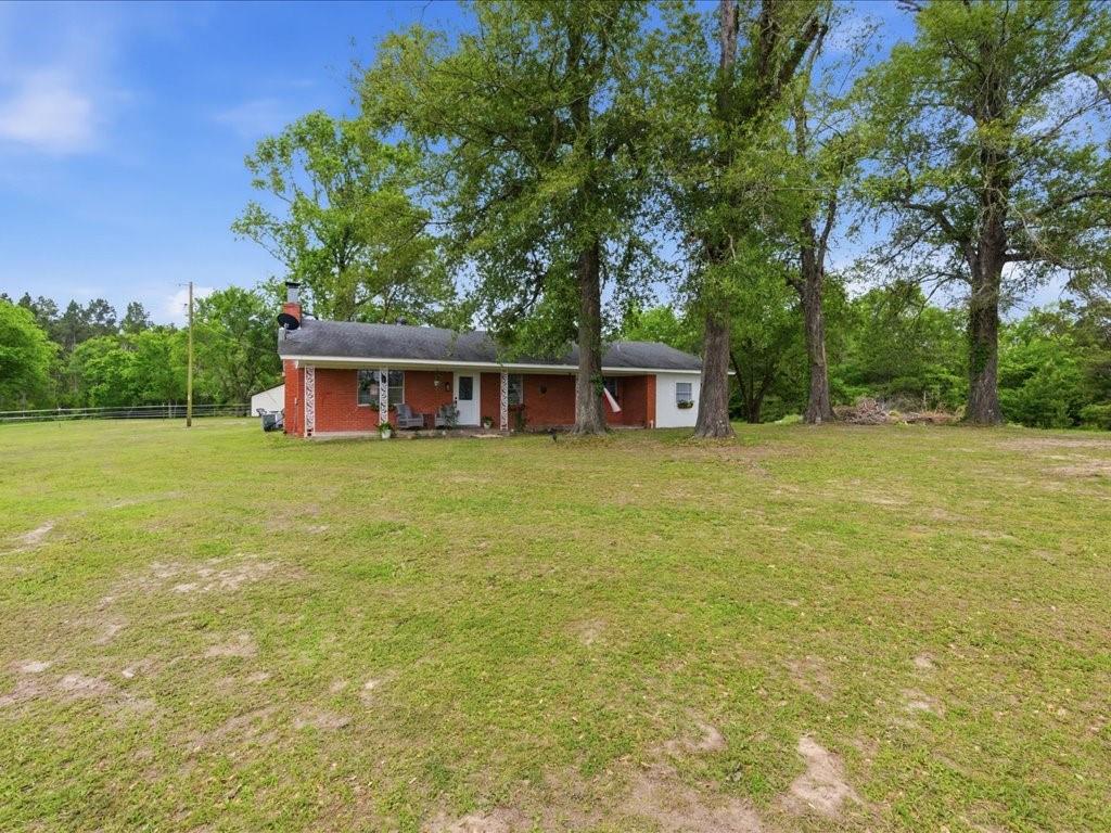 1085 Duke Road Kennard, TX 75847 - Photo 38 of 40 Red brick exterior with a covered front porch featuring white columns