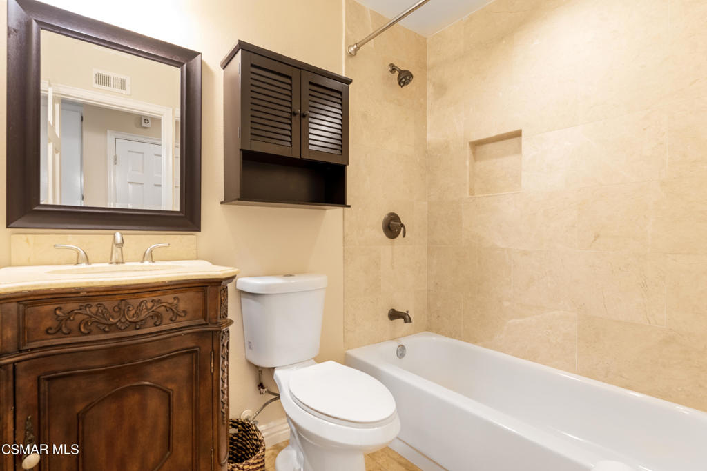 932 Thistlegate Road Oak Park, CA 91377 - Photo 18 of 25 a bathroom with a granite countertop toilet sink and mirror