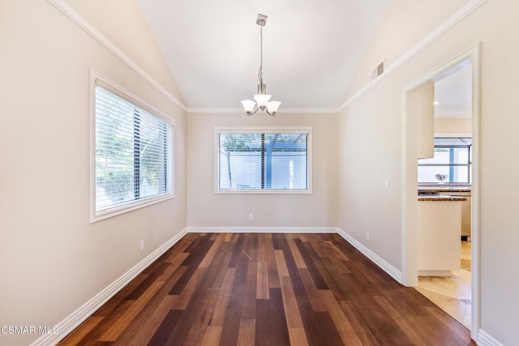 932 Thistlegate Road Oak Park, CA 91377 - Photo 5 of 25 a view of a room with wooden floor chandeliers and kitchen view
