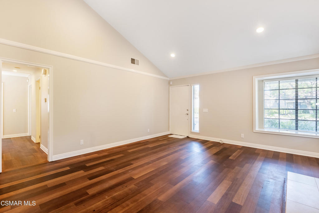 932 Thistlegate Road Oak Park, CA 91377 - Photo 6 of 25 an empty room with wooden floor and windows