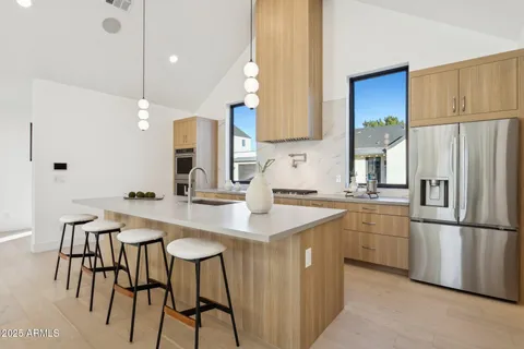 a kitchen with cabinets and chairs