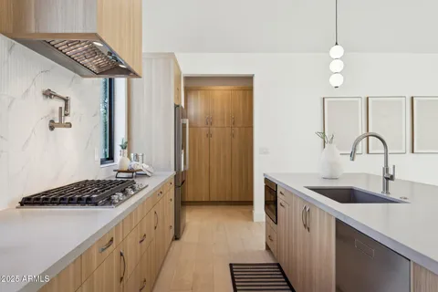 a kitchen with appliances cabinets and furniture