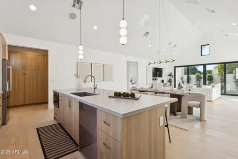 a kitchen with stainless steel appliances a sink stove and cabinets