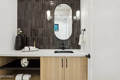 a kitchen with a stove a sink a window and chairs