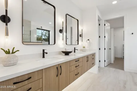 a bedroom with a bed and dresser with mirror