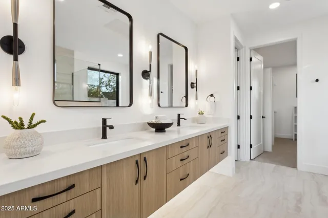 a bedroom with a bed and dresser with mirror