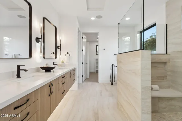a bathroom with a double vanity sink mirror and