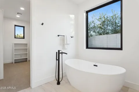 a bathroom with a double vanity sink a mirror and a shower