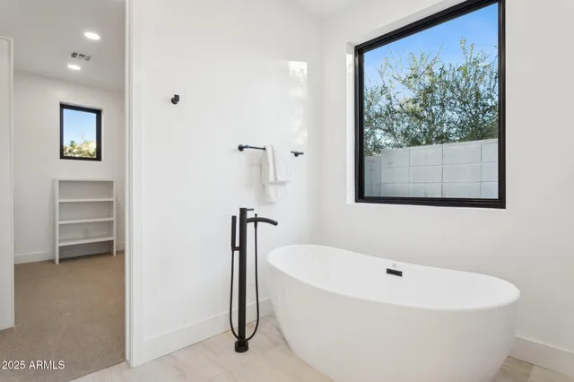 a bathroom with a double vanity sink a mirror and a shower