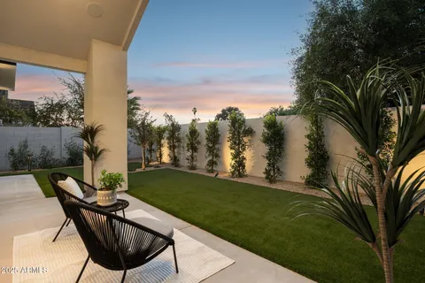 a view of balcony with a table and chairs and a potted plant