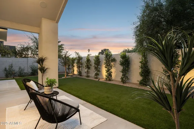 a view of balcony with a table and chairs and a potted plant
