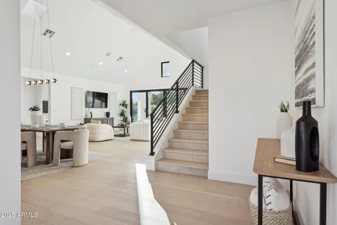 a living room with furniture kitchen view and a large window