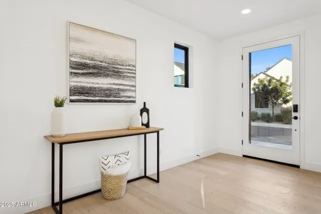 a view of a living room and entryway with furniture