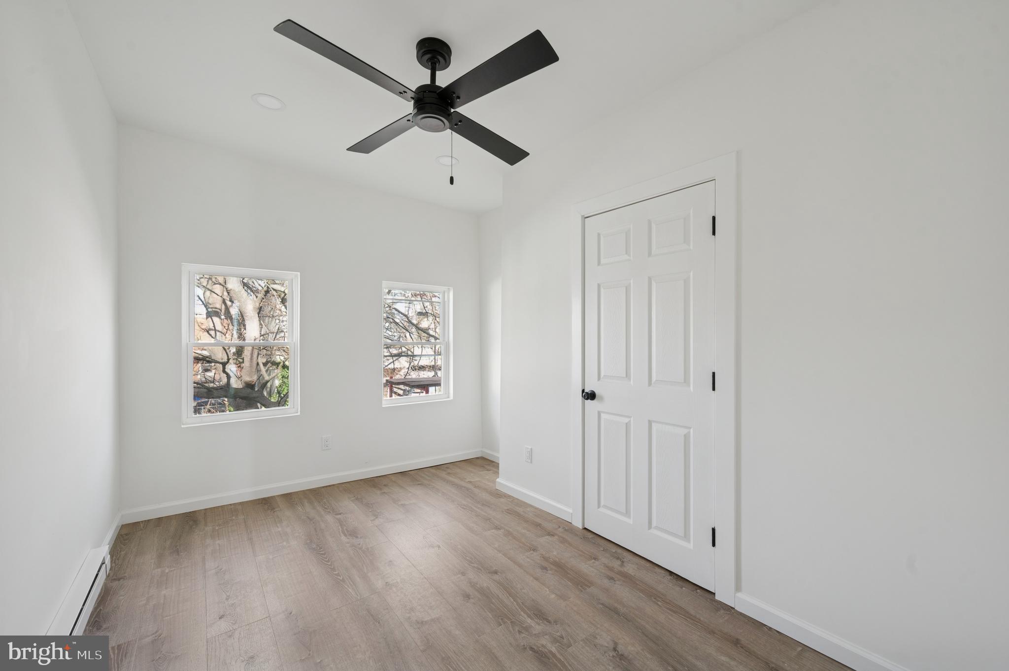 5929 Spring Street Philadelphia, PA 19139 - Photo 11 of 15 an empty room with wooden floor and windows
